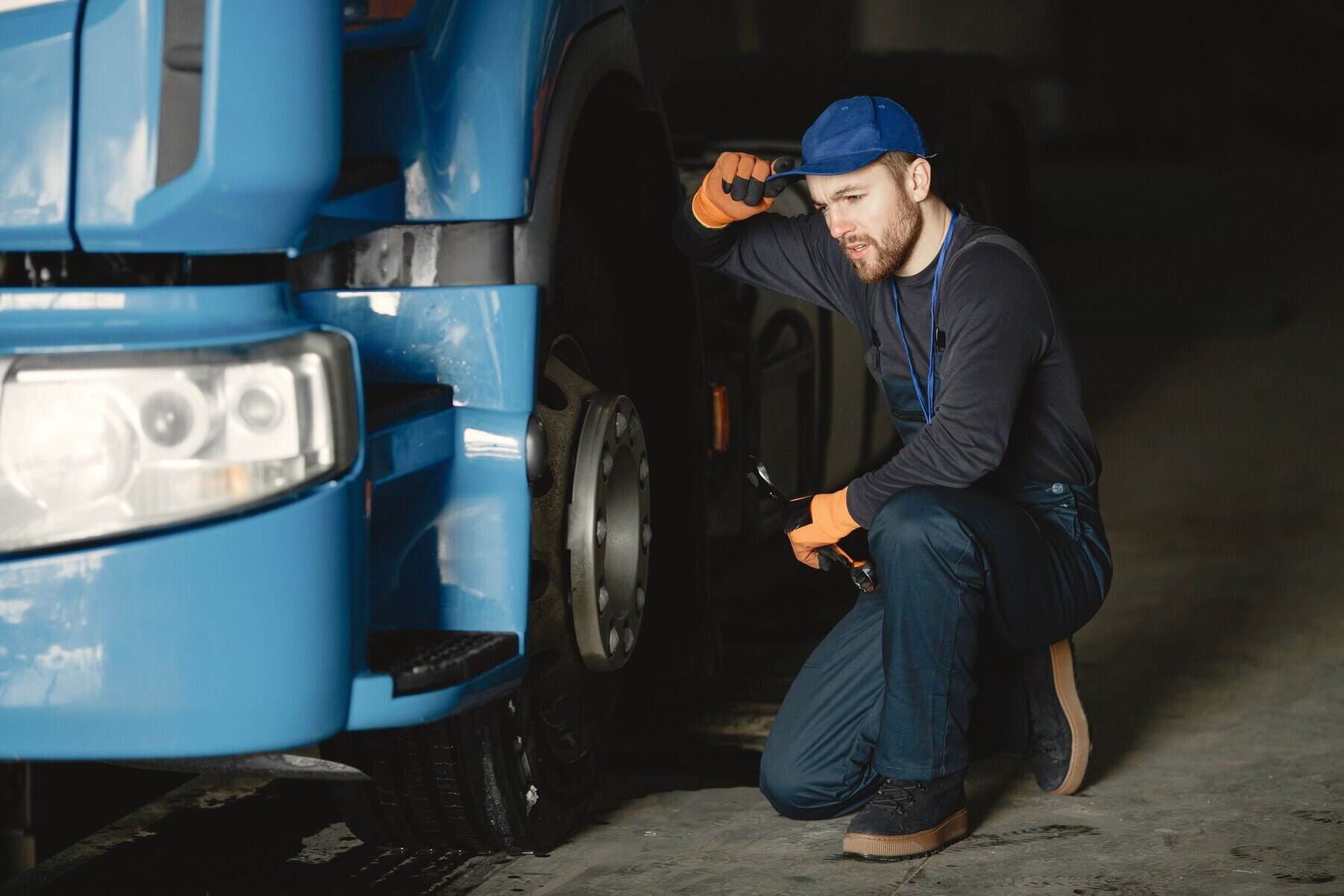 young-worker-checks-wheel-truck-malfunction-service-work_1157-46512.jpg