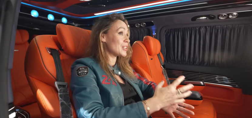 Woman enjoys voice assistant services in a luxury vehicle.