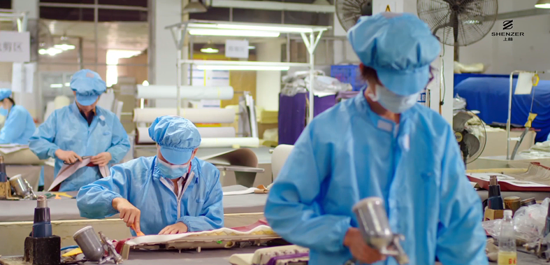 Inside the Shenzer Automotive factory, workers are meticulously crafting car interiors.