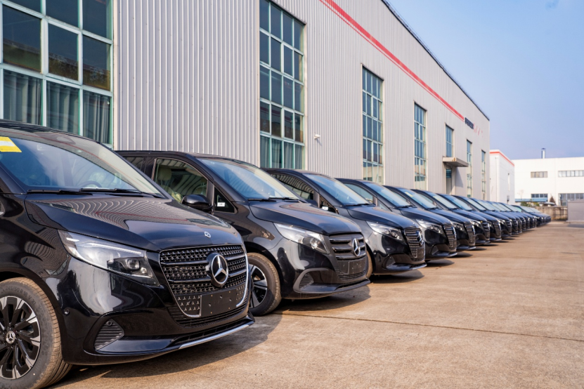 Customized Mercedes-Benz V-Class vans lined up outside Shenzer Auto's facility.