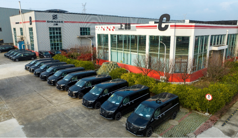 A lineup of customized Mercedes-Benz vans parked outside Shenzer Auto modification facility.