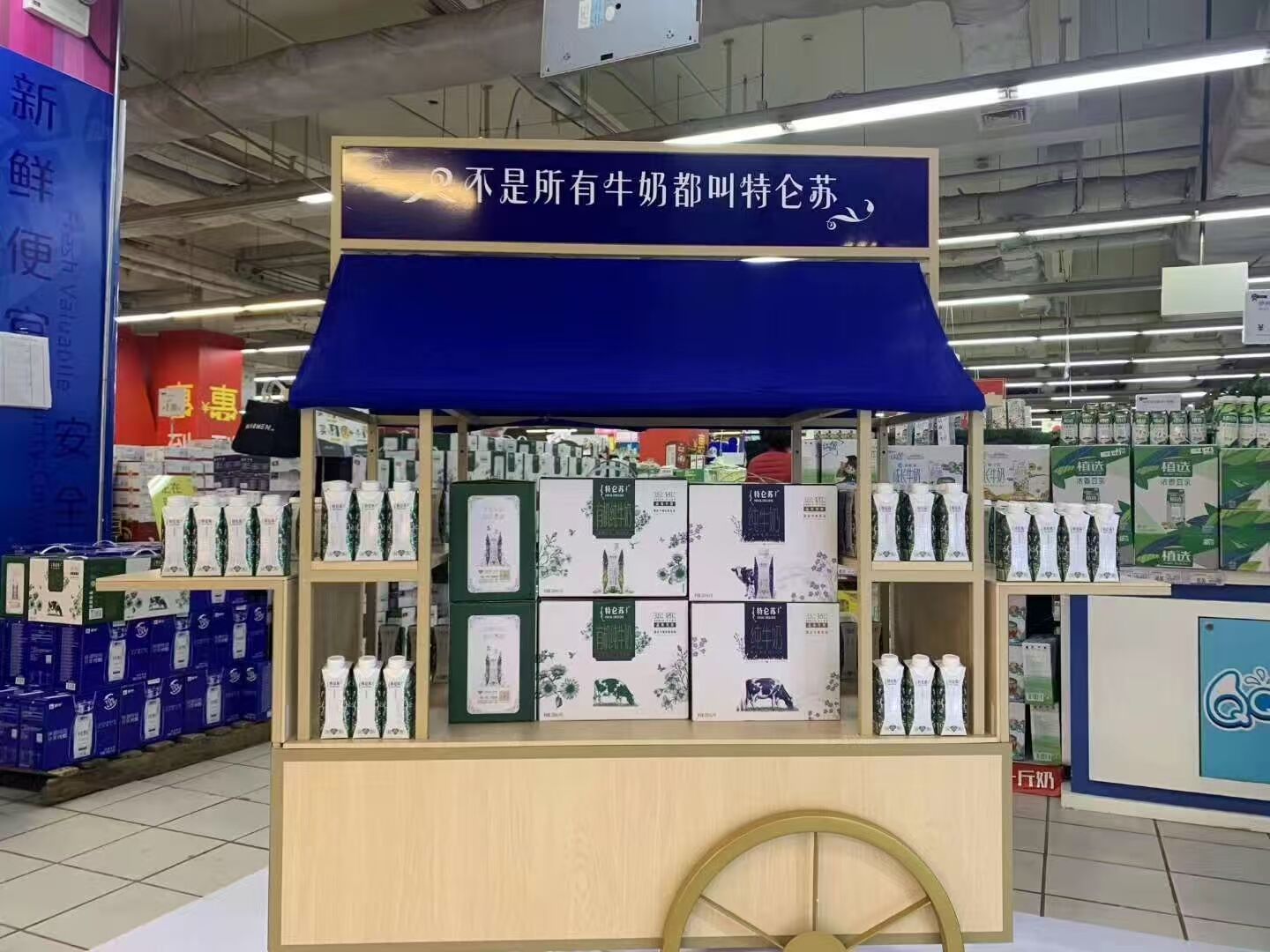 Milk product retail display with full-height branding and organized visual merchandising layout.jpg