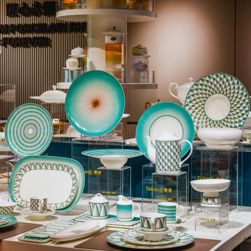 Commercial ceramic dinnerware display inside the Taitang showroom featuring modern geometric emerald green and white porcelain plates for restaurant procurement.jpg