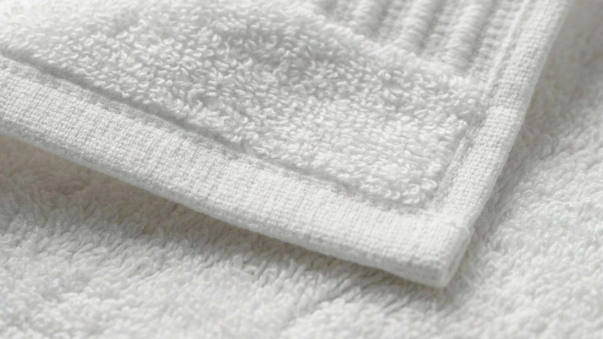 Close-up detail highlighting the dense terry weave and durable ribbed dobby border of a professional-grade Taitang bath towel..jpg