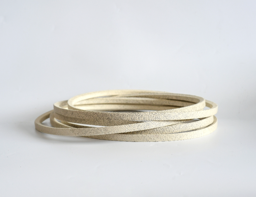 What lawn mower belt materials resist wear from debris?