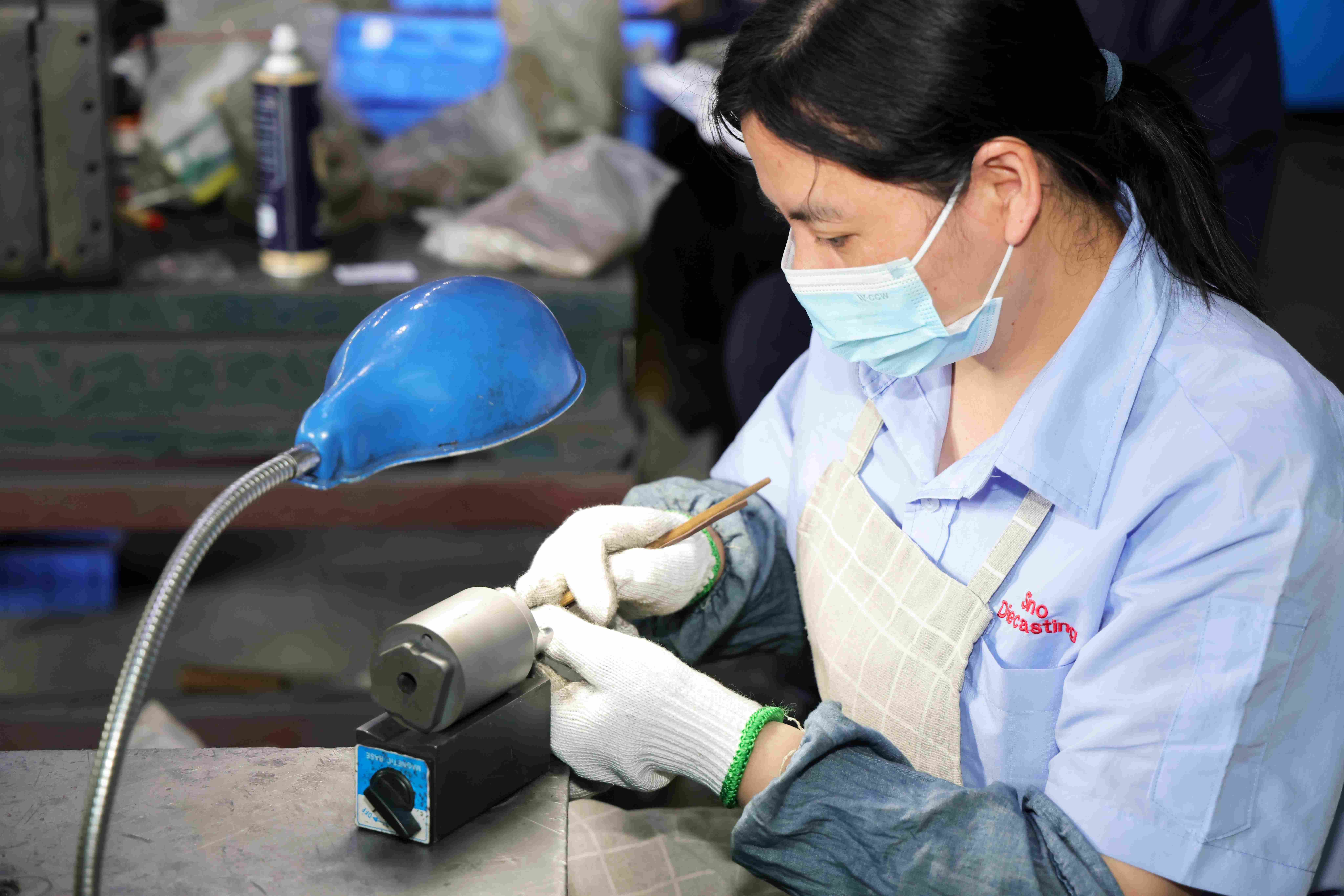 Technician performing preventive mold maintenance to ensure dimensional accuracy in die casting production