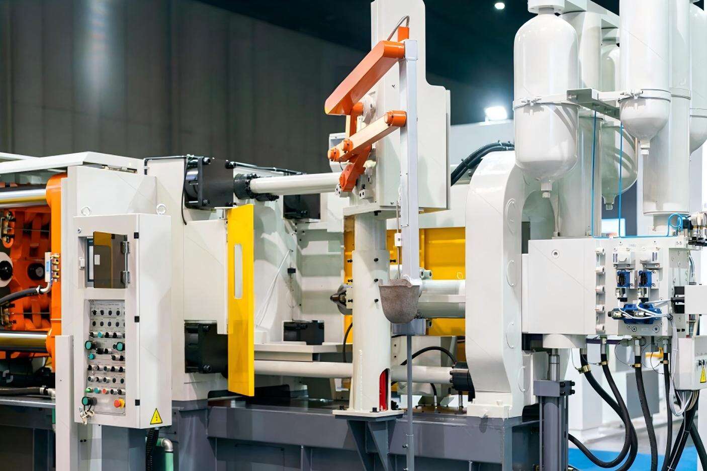 Operator managing aluminum die casting process injecting molten metal into steel molds