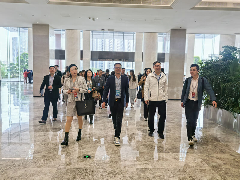 Xiamen University EMBA delegation walking through BGI Group modern lobby during corporate visit.jpg
