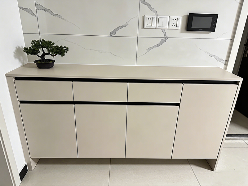 Minimalist beige entryway cabinet with artificial quartz wall backdrop for hallway storage.png