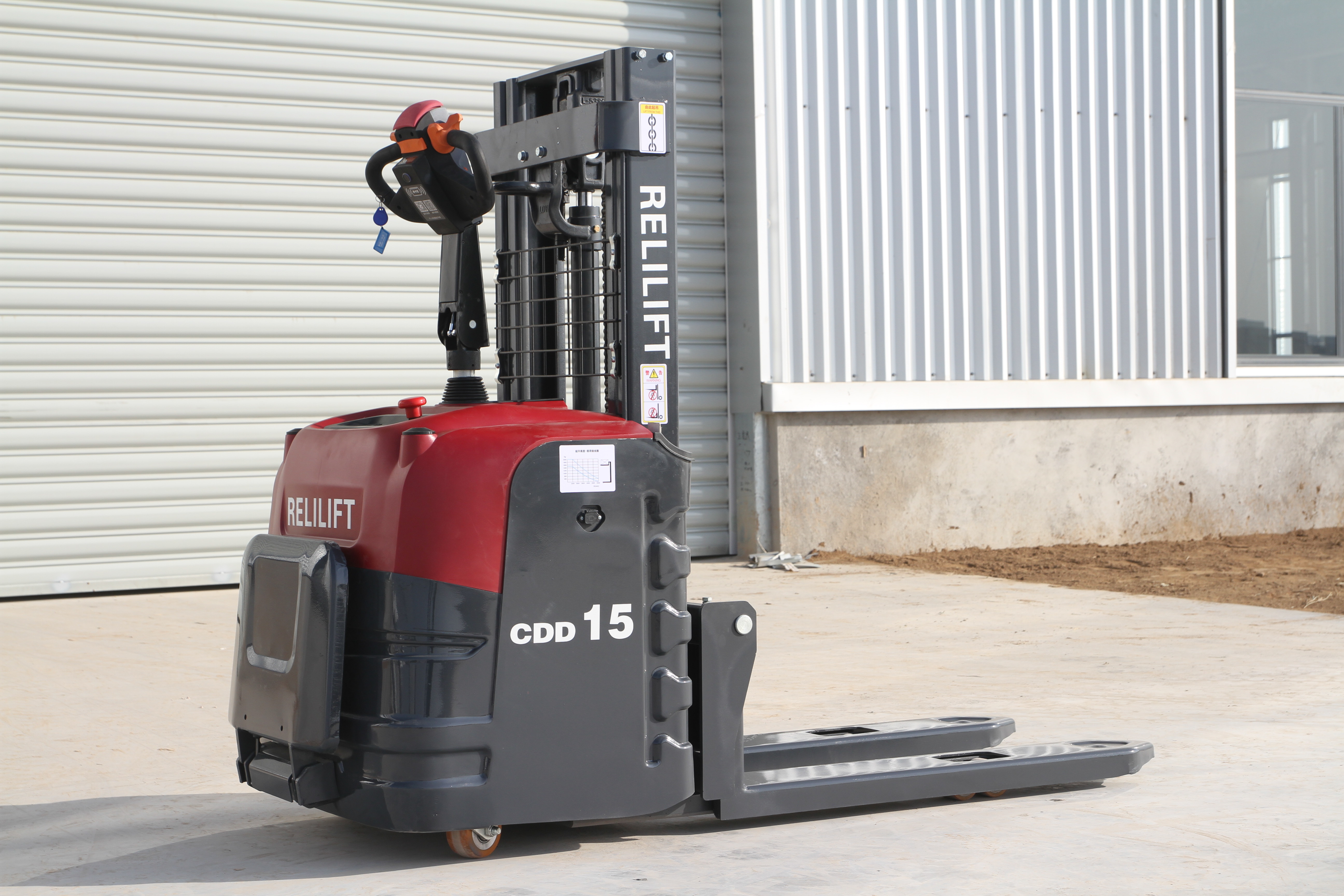 Red 1.5t electric stacker with 2m lift height in warehouse.jpg