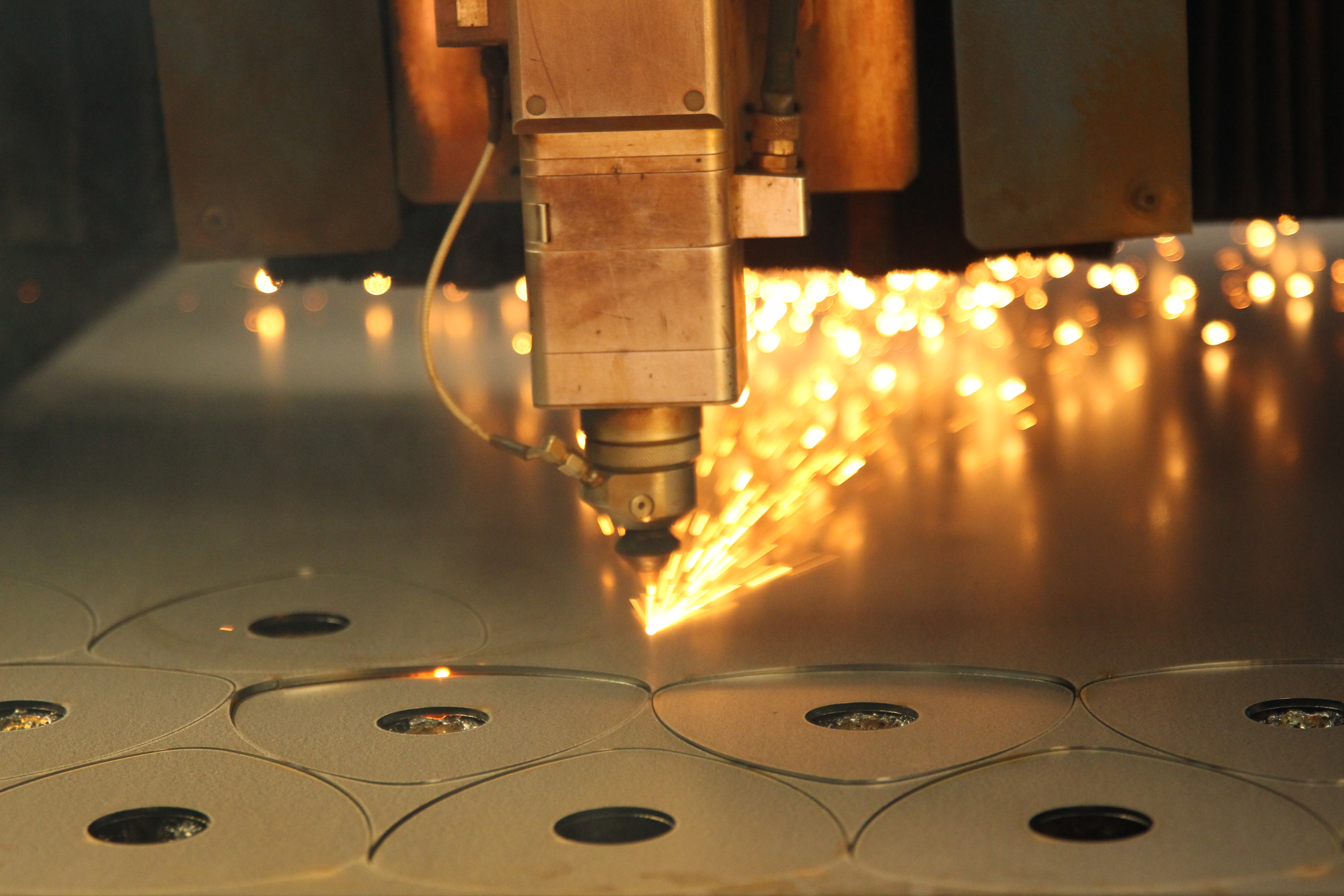 cnc fiber laser cutting machine precisely processing sheet metal in a modern manufacturing facility