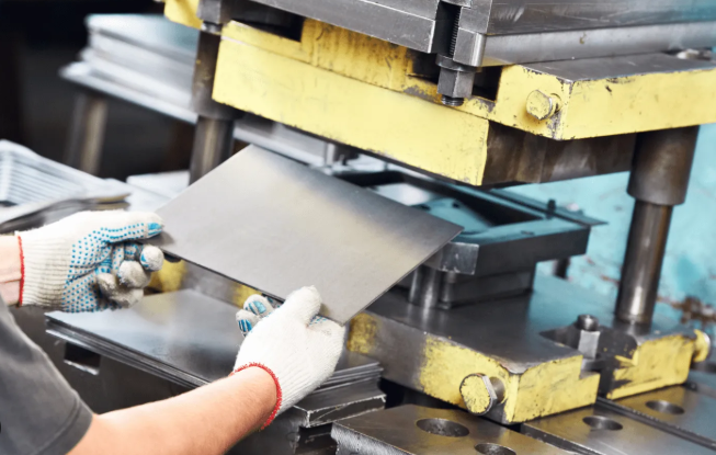 stamping process forming sheet metal through punch and die action