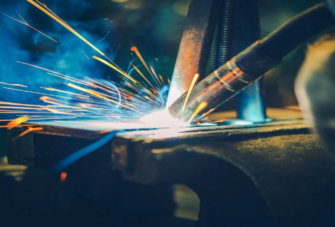 a welder checking common mig issues at the gun and wire feeder