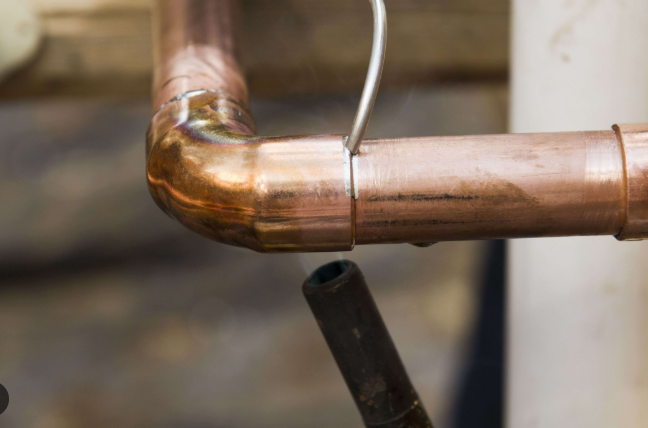 feeding solder into a heated copper joint