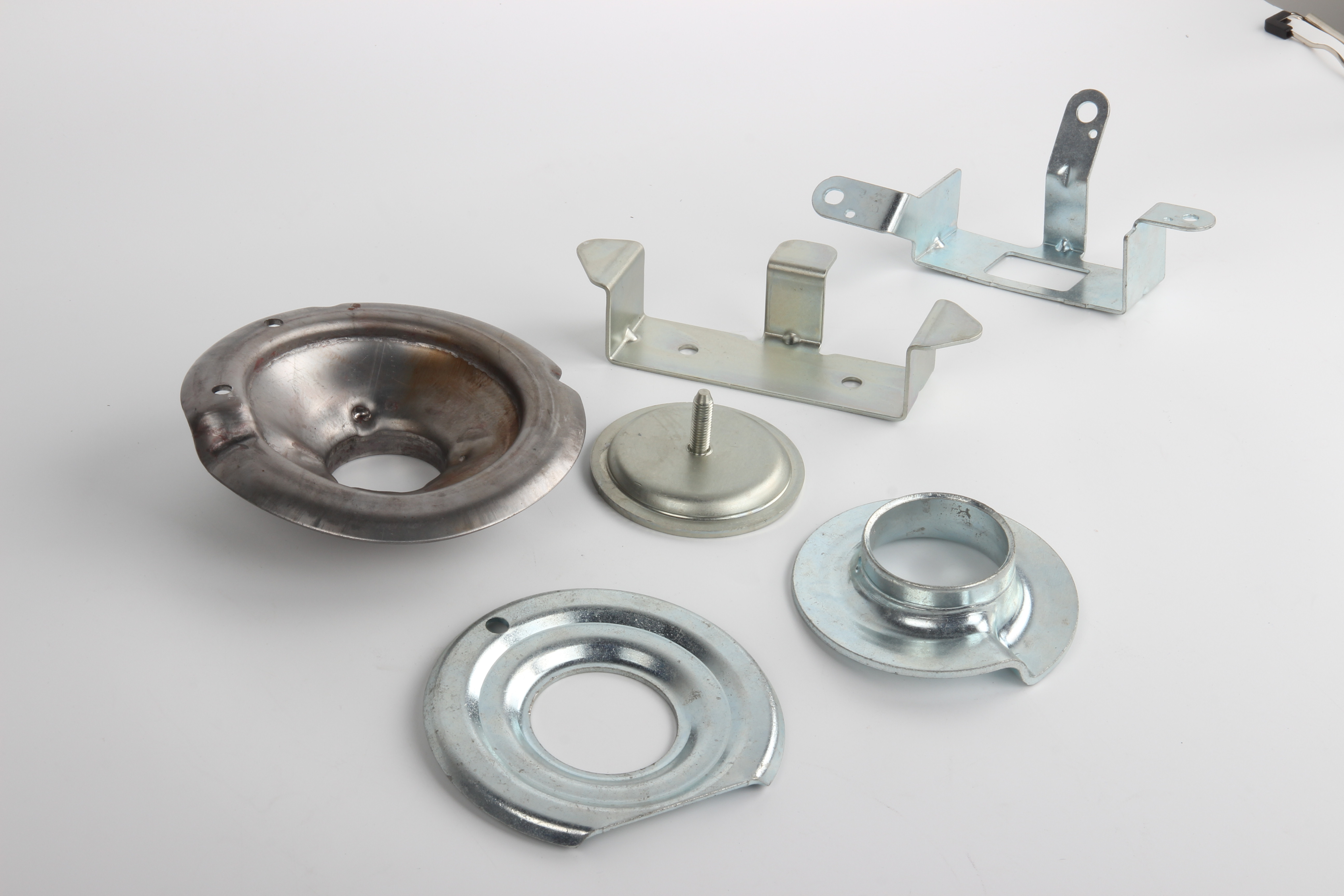 variety of custom fabricated sheet metal parts showcasing different materials and finishes