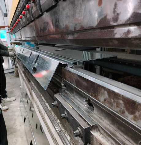 press brake forming operation creating precise bends in sheet metal components