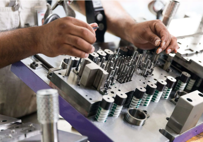 an automotive tooling team reviewing a stamping die before production launch