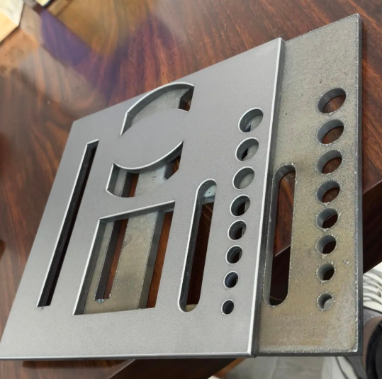 engineering team reviewing prototype sheet metal components during new product development