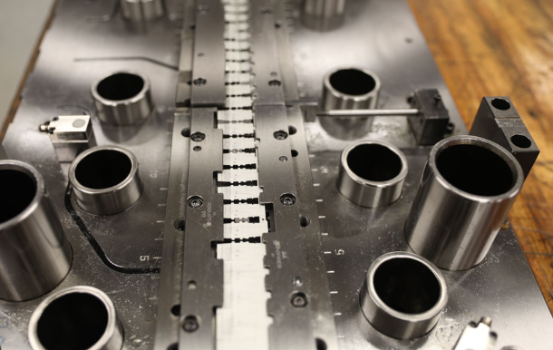 exploded view of stamping die assembly revealing critical precision components and their arrangement