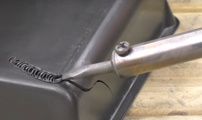 repairing a crack in plastic with matching filler and controlled heat