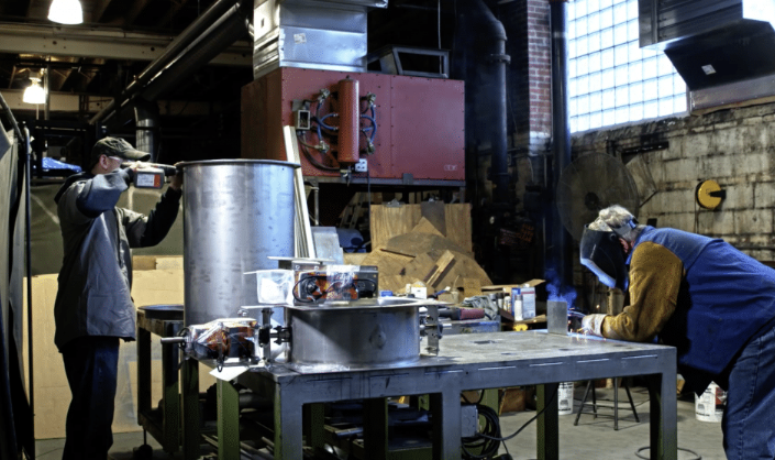 sheet metal worker fabricating and fitting metal parts in shop and field