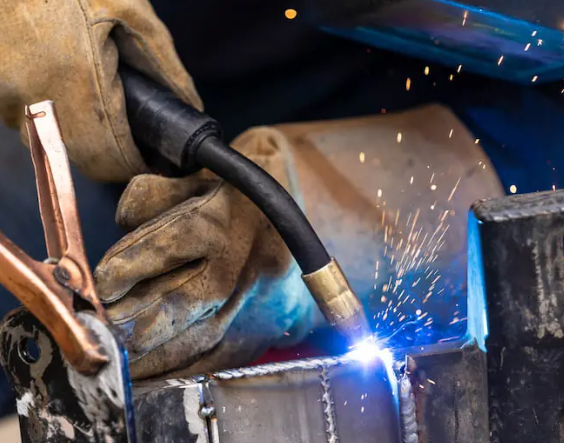mig welding setup with gun wire feed and shielding gas in a workshop