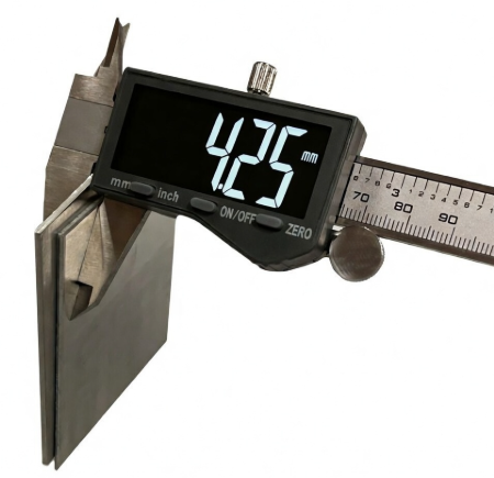 sheet metal samples and a caliper illustrating 24 gauge thickness