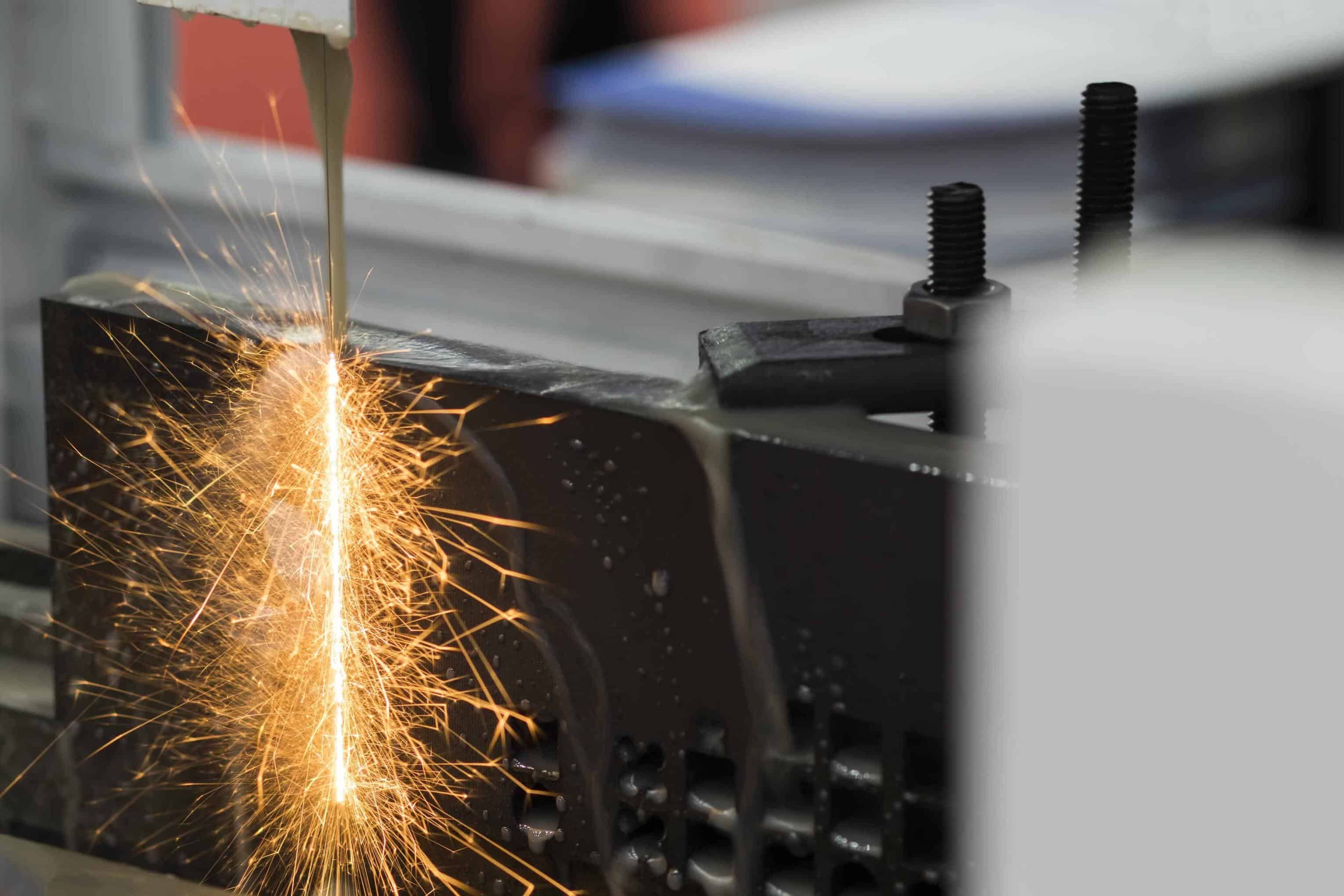 electrical discharge machining uses precisely controlled sparks to cut hardened materials impossible to machine conventionally