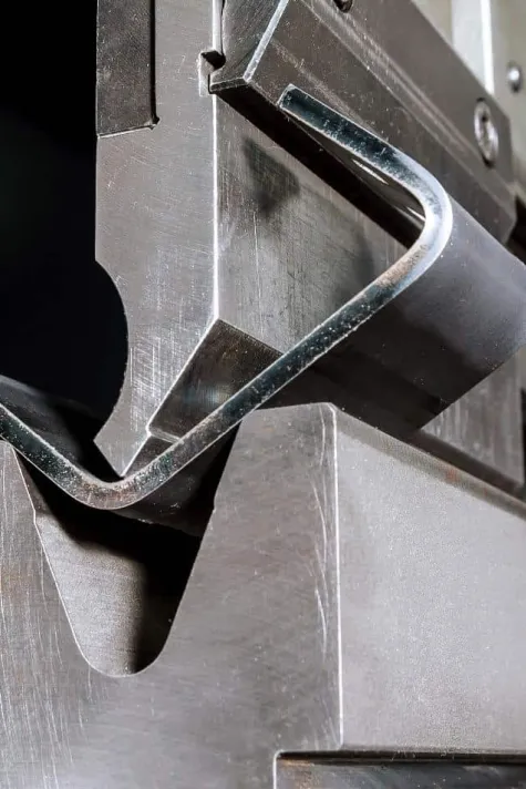 sheet metal clamped in a vise with straight bars for a no brake bend