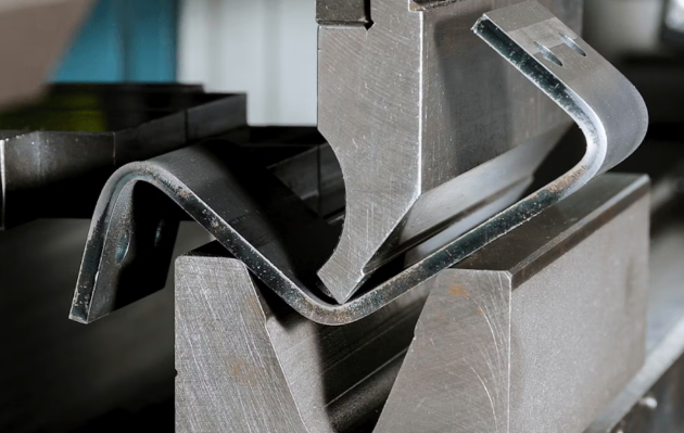 marked sheet metal clamped and supported close to the trim line