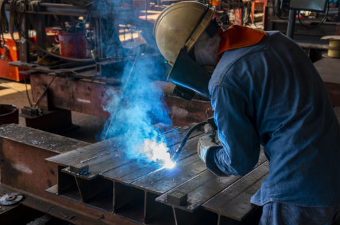 flux core welder creating an arc on steel in a workshop