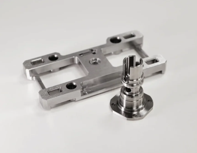 design engineer reviewing cad specifications alongside cnc machined prototype samples