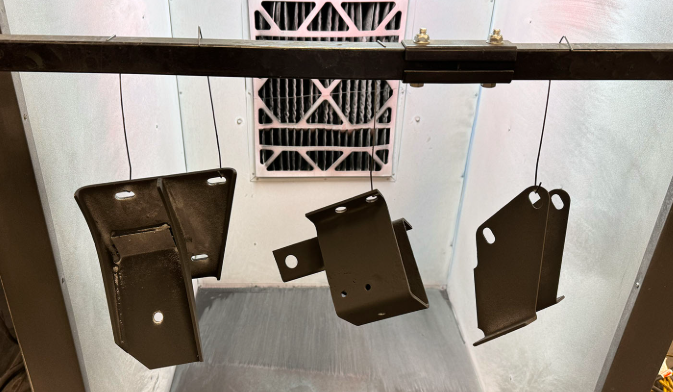 bracket finishing progression from raw laser cut edges to powder coated surfaces