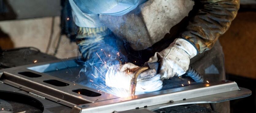 welder repairing a cracked cast iron part with careful heat control