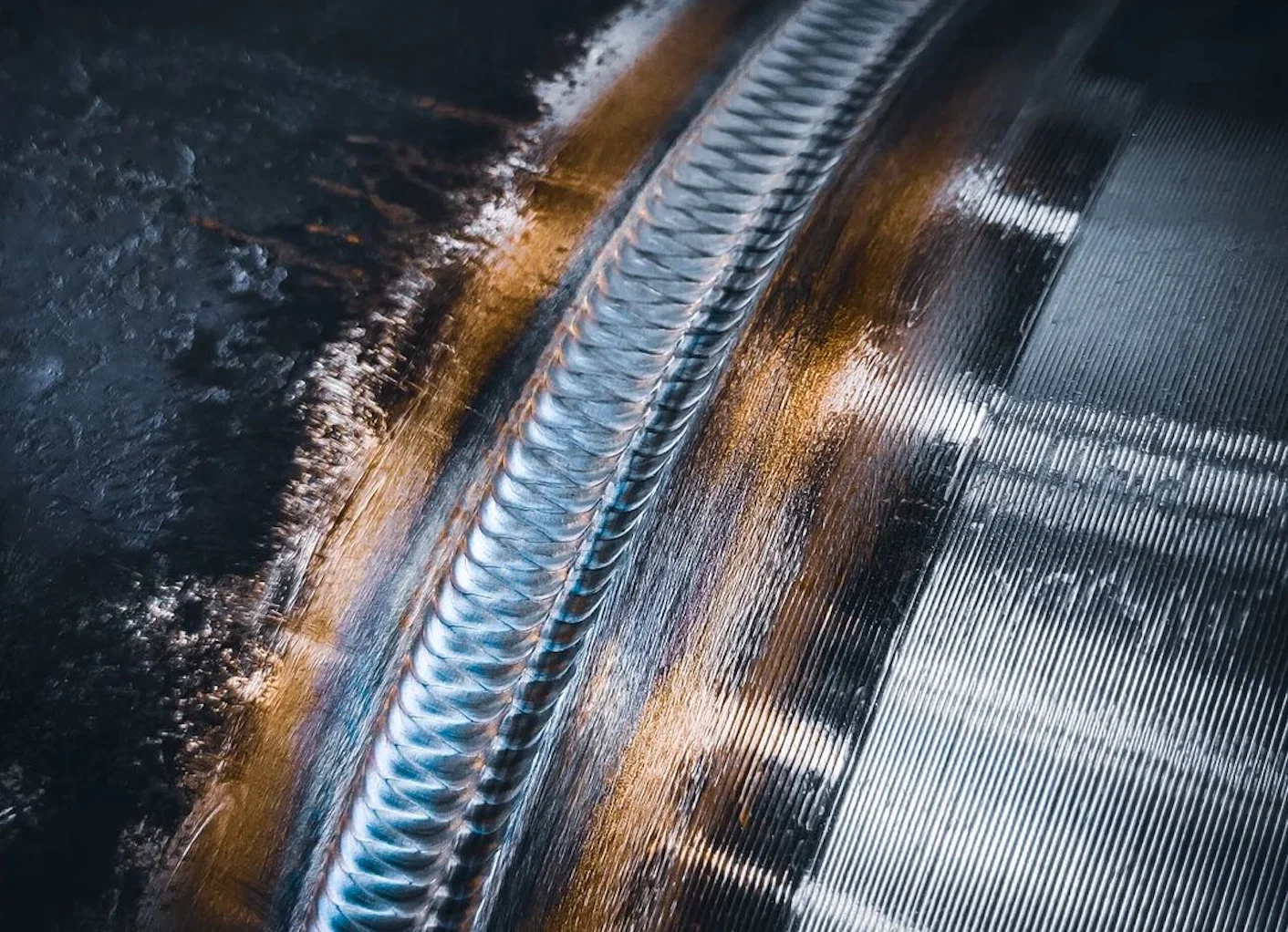 common tig shielding gas options beside a torch and metal samples