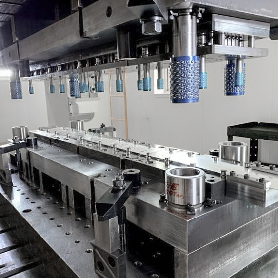 cross section view of progressive die stations performing sequential metal forming operations
