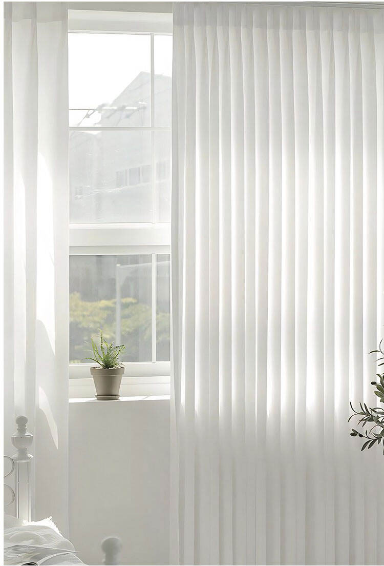 White polyester sheer curtains with soft pleats in a sunlit interior, creating an airy, elegant window treatment.