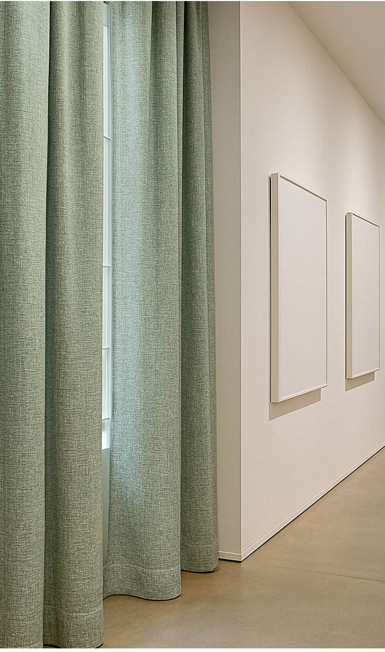 Green heavy-slub curtains in a gallery-like corridor, elegant drape with soft light and depth.