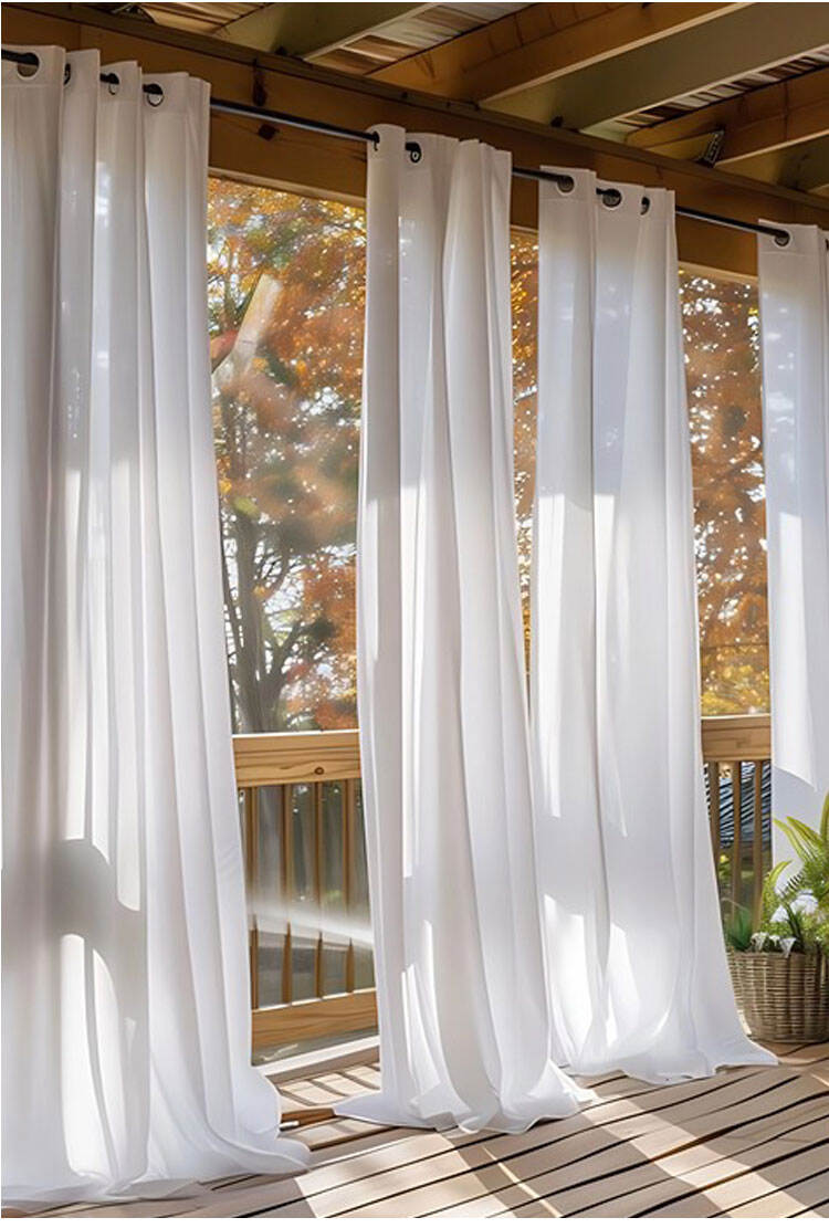 Outdoor balcony scene with white sheer curtains on grommet top, flowing in sunlight for a fresh, breathable feel.