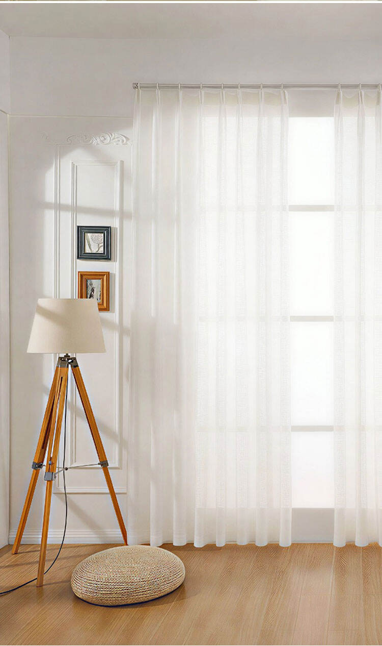 White sheer curtain on a large window in a modern room, showing uniform mesh and a clean minimal look