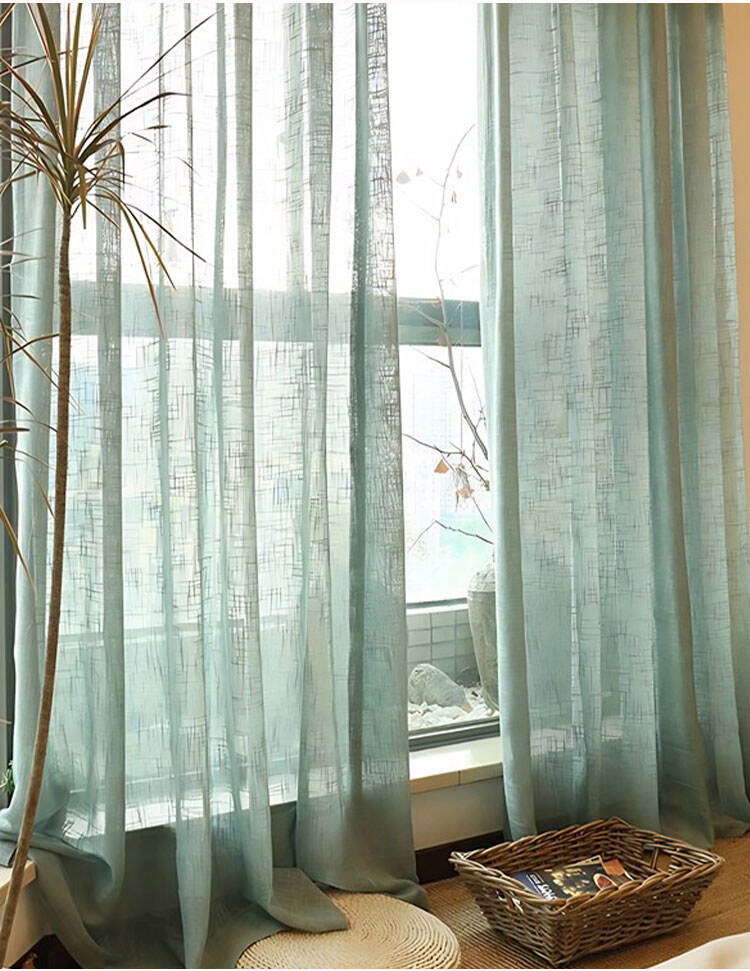 Light blue-green yarn-dyed sheer curtains in a cozy reading nook, softly filtering daylight for calm interior ambience.