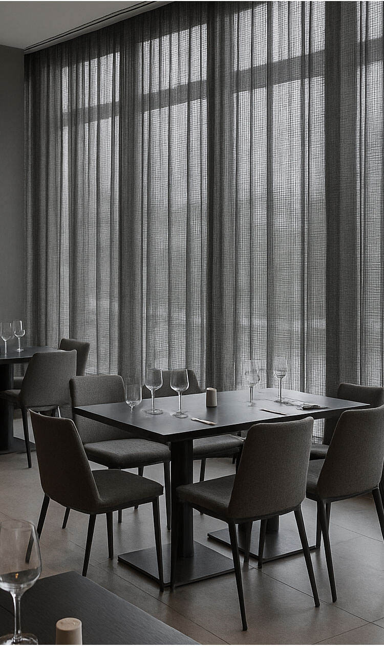 Close-up interior scene behind sheer curtains with soft filtered light, highlighting texture and privacy balance.