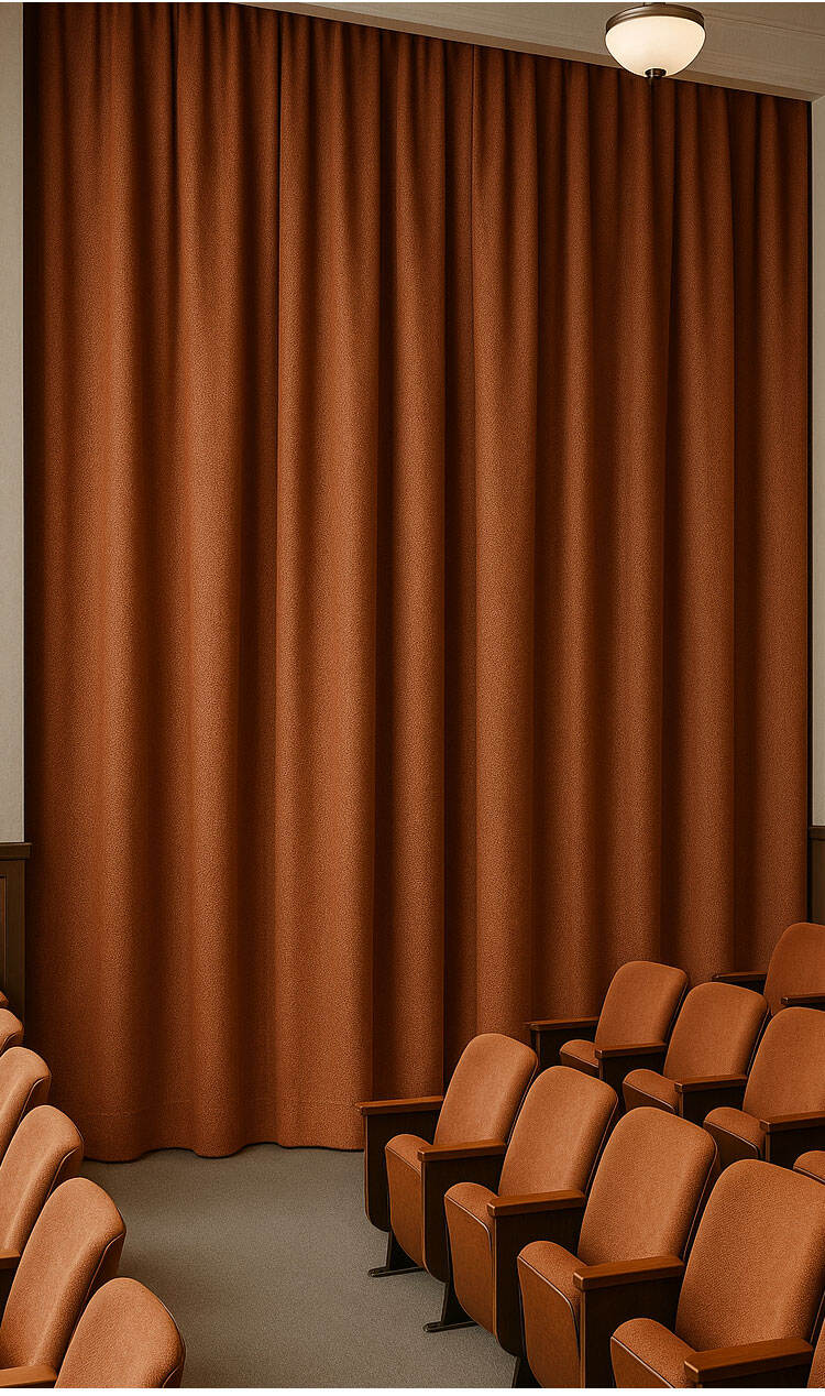 Rust-brown curtains in an auditorium/theater setting, highlighting depth of color and durable drapery presence