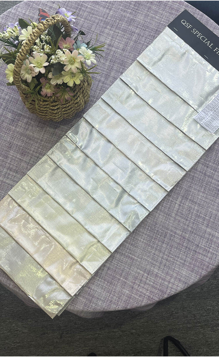 Lurex glitter fabric sample swatches displayed on a sample card, showing subtle metallic shine and color options.