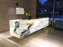 How do translucent stones perform in commercial lighting designs?